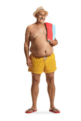 Mature man in swimming shorts holding a towel