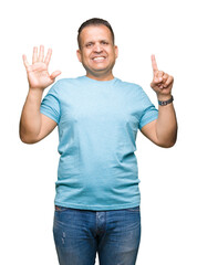 Fototapeta premium Middle age arab man wearing blue t-shirt over isolated background showing and pointing up with fingers number six while smiling confident and happy.