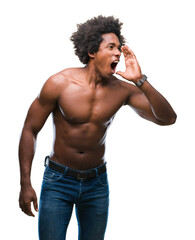 Fototapeta premium Afro american shirtless man showing nude body over isolated background shouting and screaming loud to side with hand on mouth. Communication concept.