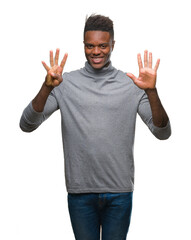 Young african american man over isolated background showing and pointing up with fingers number nine while smiling confident and happy.