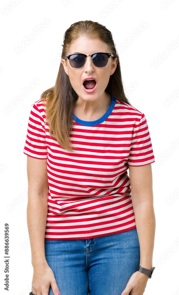 Canvas Prints Middle age mature woman wearing sunglasses over isolated background afraid and shocked with surprise expression, fear and excited face.