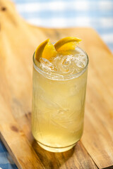 long iced orange drink on wooden board