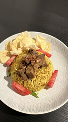 Arabian fried rice cooked with fried lamb, rice, garlic, tomatoes, and emping melinjo crackers