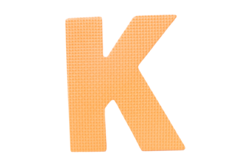 Jigsaw foam plastic orange English uppercase "K" alphabet isolated on cut out PNG or transparent background. Character. Colorful foam alphabet puzzle pieces used in learning education for children.
