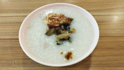 porridge with century egg and fried shallot toppings