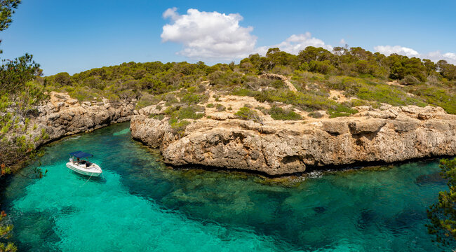 Aerial view of boat sailing in a cove, Cala Beltran, Llucmajor, Majorca, Balearic Islands, Spain