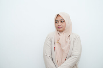 Fototapeta premium Portrait of a beautiful young Asian Muslim woman wearing a hijab being photographed in a studio