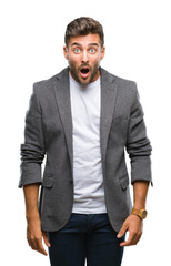 Young handsome business man over isolated background afraid and shocked with surprise expression, fear and excited face.