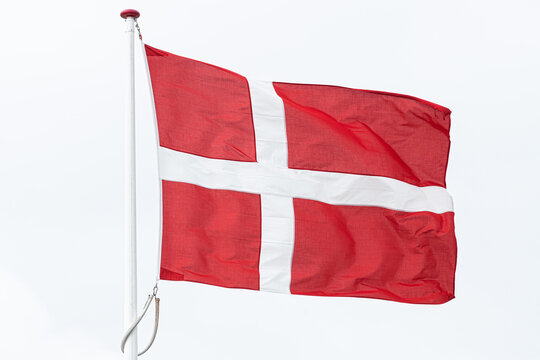 Close-up of a Danish Flag on a flagpole against a white background