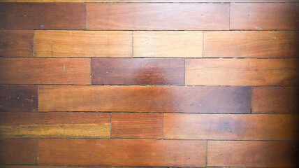 The warm glow of the natural wood floor surface material background. The cozy atmosphere of wooden tile surface background.