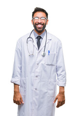 Adult hispanic doctor man over isolated background sticking tongue out happy with funny expression. Emotion concept.