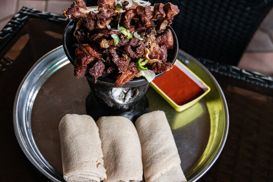 Shekla Tibs is a savory Ethiopian national meal of sauted meat and spices, traditionally served in a clay pot with injera