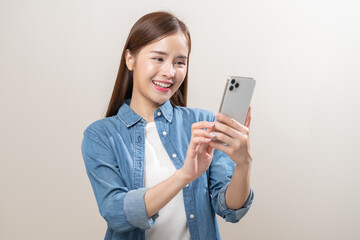 Naklejka premium Happy asian young woman using mobile smart phone, read good news online, laugh excited getting offer, great positive surprise, celebrate success on smartphone. Smile girl isolated on white background.
