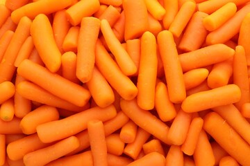 Many baby carrots as background, top view