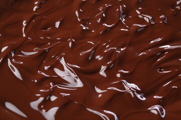 Delicious melted chocolate as background, closeup view