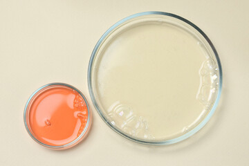 Petri dishes with samples on beige background, top view