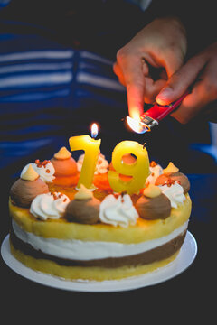 Close-up of a person Lighting a 79th birthday cake