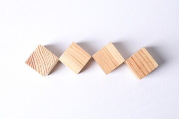 Many blank wooden cubes on white background, top view