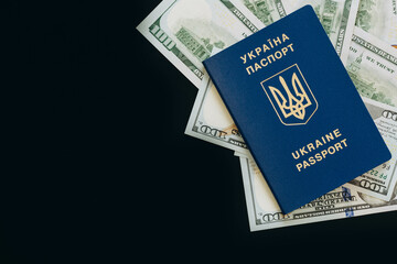 Biometric Ukrainian passport and money on a black background, copy space.