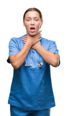 Young caucasian doctor woman wearing medical uniform over isolated background shouting and suffocate because painful strangle. Health problem. Asphyxiate and suicide concept.