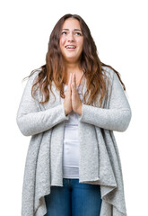 Beautiful plus size young woman wearing winter jacket over isolated background begging and praying with hands together with hope expression on face very emotional and worried. Asking for forgiveness