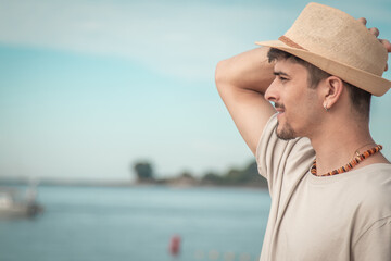 free smiling young man on beach background