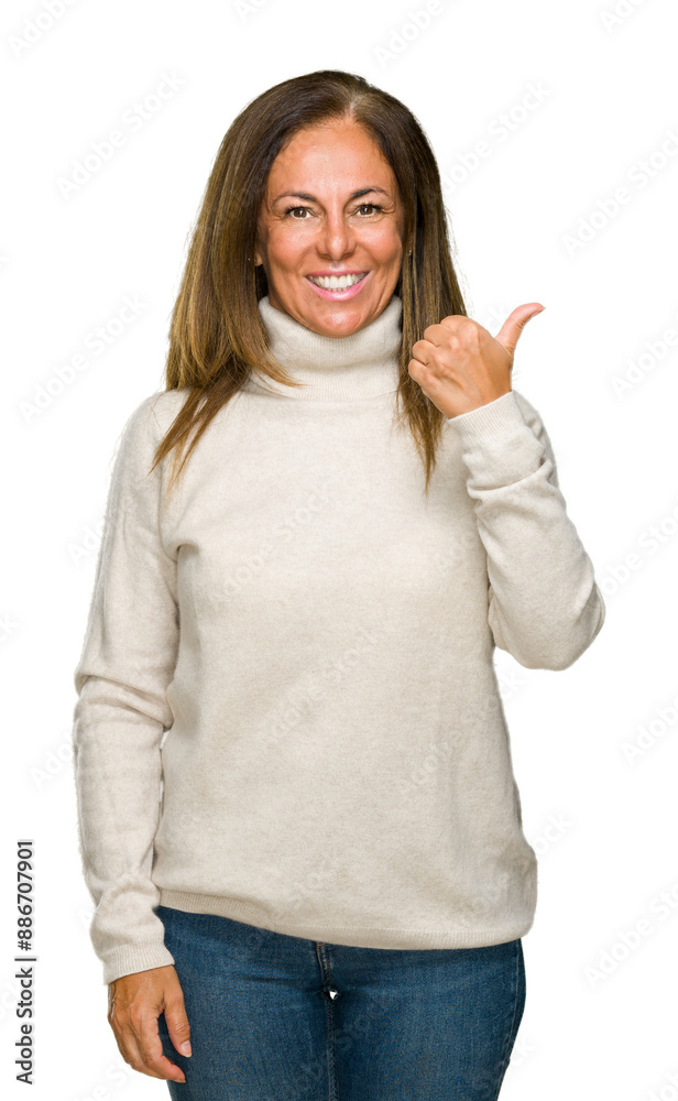 Wall mural beautiful middle age adult woman wearing winter sweater over isolated background doing happy thumbs 