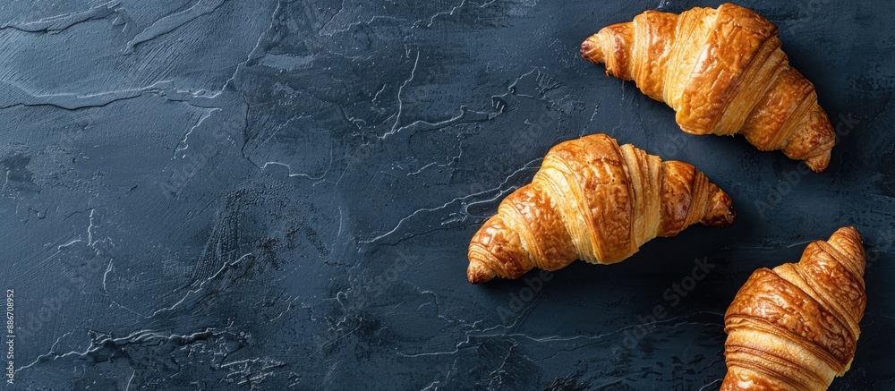 Canvas Prints Vintage dark background displaying fresh traditional French croissants from an overhead perspective with blank space for imagery. Copy space image. Place for adding text and design