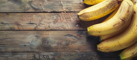 Bunch of bananas displayed on a vintage wooden surface with a clear area for additional images