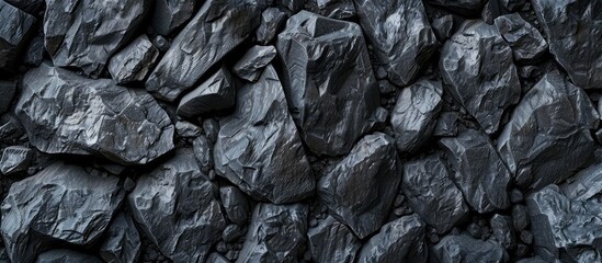 Stone background with black texture resembling mountain rocks creating an abstract copy space image for designers resembling asphalt or coal with dark hues