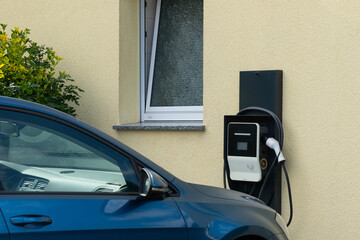 Electric car charging at home. Close-up.