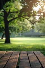 Fototapeta premium Wooden picnic table in park with greenery and trees. Rustic charm outdoor setting. Perfect for product display or background image. Nature scenery for advertising, marketing, or editorial use.