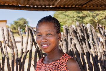 village african single young woman with braids standing a shed