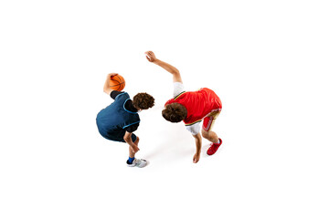 Dynamic shot of two young basketball athletes training their skills against white studio...