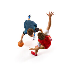 Basketball player in blue tries to outmaneuver defender in red, encapsulating thrill of game...