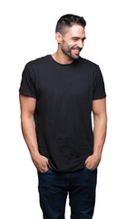 Fototapeta premium Young handsome man over isolated background looking away to side with smile on face, natural expression. Laughing confident.