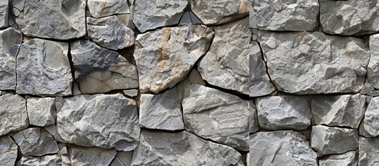 Fototapeta premium Stone wall backdrop in gray cement with seamless tiling texture for design featuring a blank copy space image