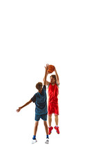 Basketball player in blue taking precise shot, while his opponent in red leaps to block, against white studio background, emphasizing sport's competitive spirit. Concept of sport, competition, match.