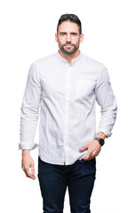 Young business man over isolated background Relaxed with serious expression on face. Simple and...