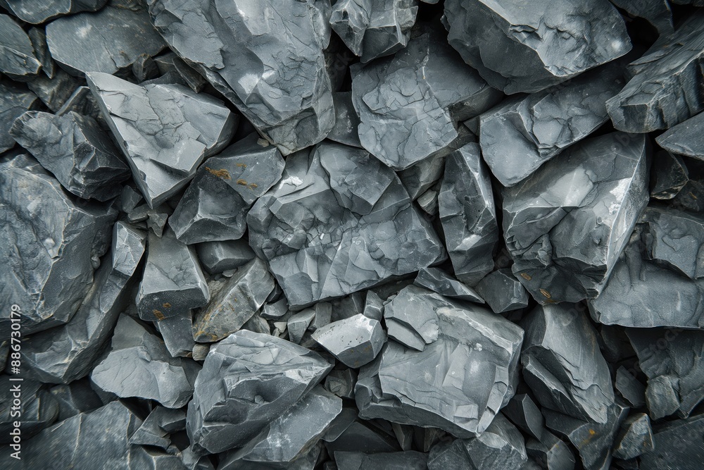 Poster Gray rocks scattered on blurred background. Close-up view of granite texture. Natural stone collection with depth and dimension. Perfect for tech, eco, or design concepts.