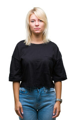 Young beautiful blonde woman over isolated background skeptic and nervous, frowning upset because...