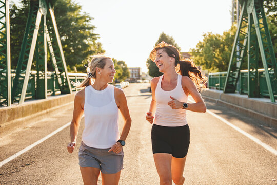 Two athletic women in sportswear is jogging together