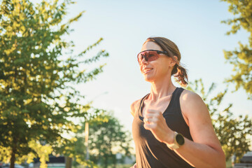 great sporty woman jogging outdoors on sunset time