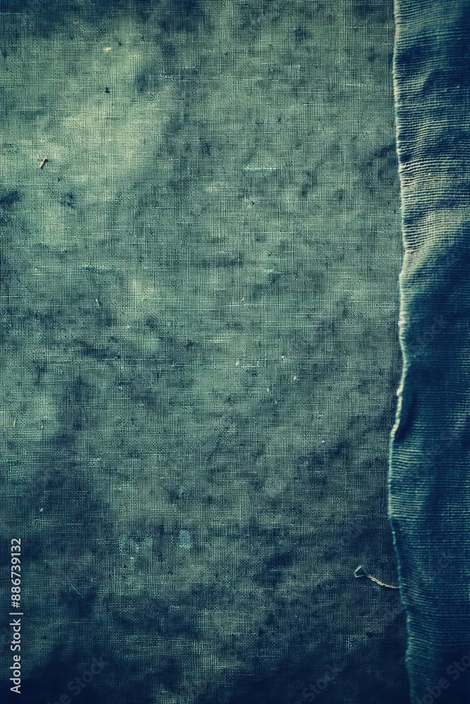 Aufkleber Close-up view of textured fabric with blue and green hues. Small tear adds imperfection to its smooth appearance. Blurred background focuses on fabric texture.