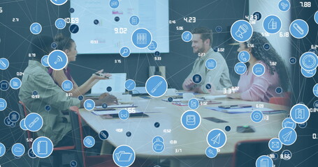 Image of network of icons over diverse colleagues discussing together at office