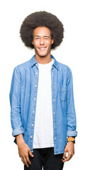 Young african american man with afro hair winking looking at the camera with sexy expression, cheerful and happy face.