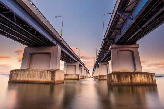 Biwako Ohashi Bridge (Lake Biwa bridge) over lake Biwa at sunset, Moriyama, Shiga, Japan