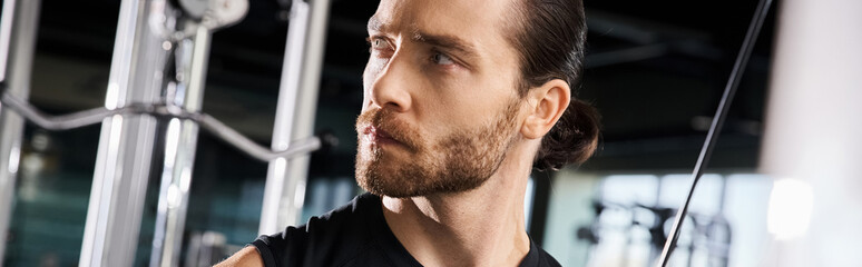 Obraz premium An athletic man in a black tank top is pushing his limits while exercising in a gym.