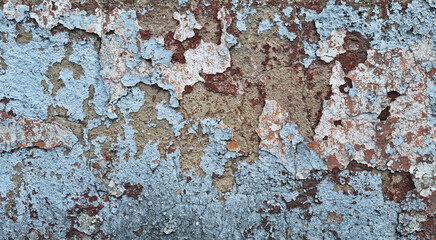 Texture of old rustic wall covered with gray and blue stucco. Multilayers of old paint on the wall. Textured background. Selective focus