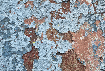Texture of old rustic wall covered with gray and blue stucco. Multilayers of old paint on the wall....